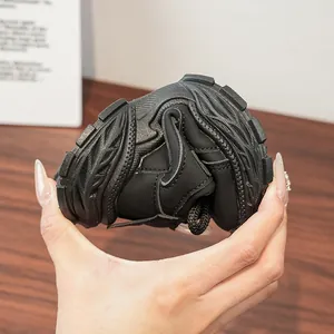 Close-up of flexible soft sole showing highly bendable black kids sports sneakers