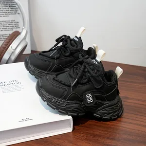 Detail of black children's chunky sneaker with LOLO logo tag and non-slip sole