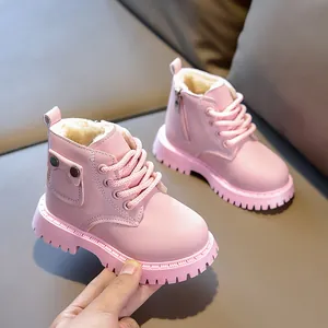 Detail of pink kids winter boots with warm plush lining and side pocket decoration