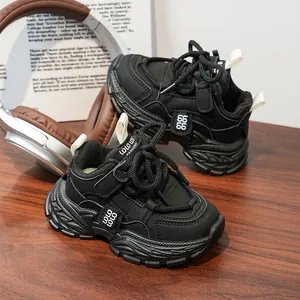 Detail of kids black chunky sneakers with wave pattern non-slip sole and Velcro strap