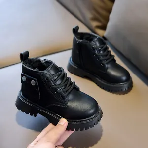 Detail view of children's warm Martin boots with thick black faux fur lining and side zipper