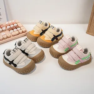 Detail view of toddler walking shoes featuring anti-collision toes and cartoon panda motifs