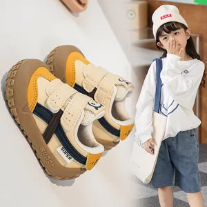 Detail of color-block kids sneakers with dual velcro straps and durable non-slip rubber sole