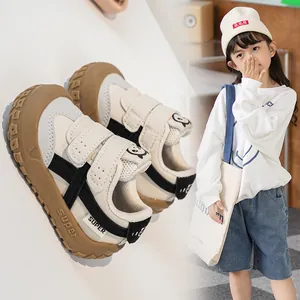 Detail of infant walking shoes with double hook-and-loop straps and cute cat pattern