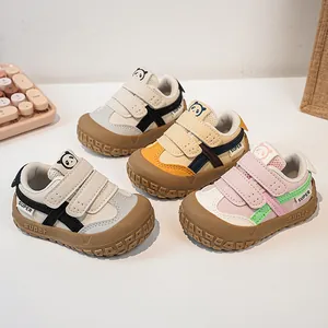 Detail of baby walking shoes with hook-and-loop closure and cartoon panda patches