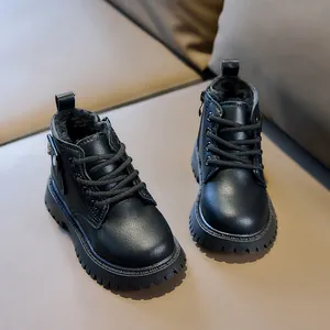 Detail of warm black faux leather kids boots with thick plush lining and side zipper