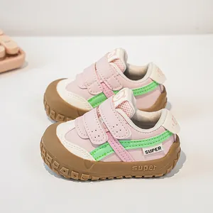 Detail view of pink and mint toddler shoes with velcro straps and anti-collision toe