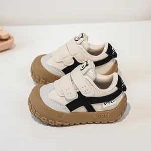 Detail of baby sneakers with double hook-and-loop straps and panda motifs