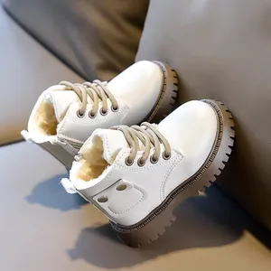 Detail of warm plush lining and side zipper on children's cream leather boots