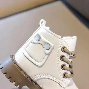 Close-up of children's beige winter boots with warm faux wool lining and thick brown soles