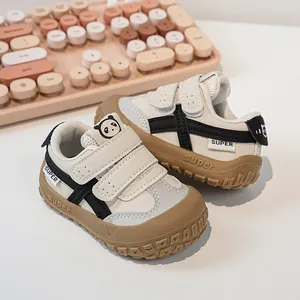 Detail of infant walking shoes with double velcro straps and protective rubber toe cap