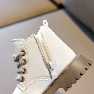 Detailed view of kids' leather boots with warm fleece lining and side zipper design