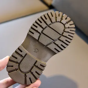 Close-up of durable rubber sole on children boots with non-slip texture and size 24 mark