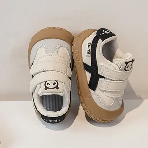 Detailed view of kids' toddler sneakers with dual hook-and-loop straps and panda icons