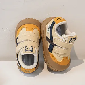 Detail of baby walking shoes with anti-slip rubber sole and cute panda emblem
