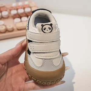 Close-up of toddler sneakers featuring a cute panda patch and durable rubber toe cap