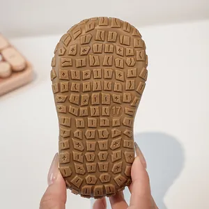 Detailed view of non-slip rubber sole with texture and size 17 marking for toddler shoes