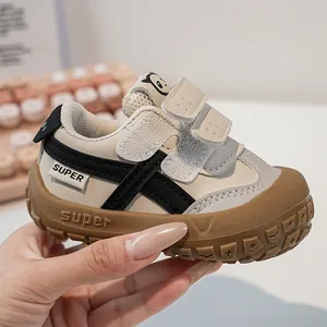 Detail of baby sneakers with double hook-and-loop straps and protective rubber toe cap