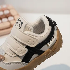 Detail of infant functional shoes with panda tongue pattern and velcro closure strap