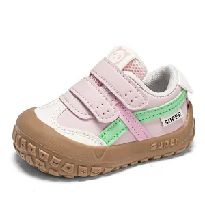Detail of pink toddler shoes featuring dual velcro straps and durable rubber anti-collision toe
