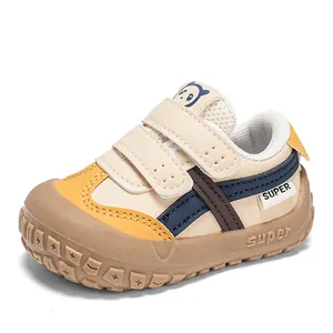 Close-up of toddler sneakers featuring double hook-and-loop straps and panda tongue detail