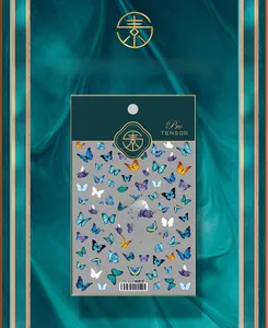 Detailed view of butterfly nail art stickers in blue and purple on a dark green velvet base