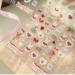 Close-up of TL436 3D embossed Christmas nail stickers with rabbits and red bows
