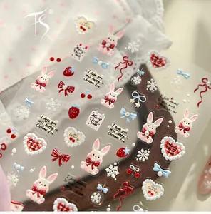 Detail of 3D embossed Christmas nail stickers featuring cute rabbits and festive bows