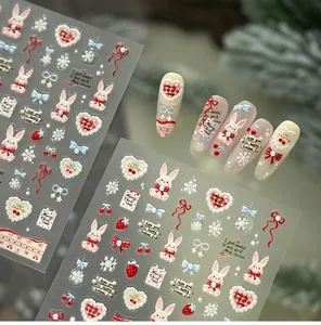 Macro view of 3D embossed Christmas nail stickers featuring rabbits and heart patterns