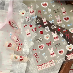 Detail of 3D embossed nail stickers featuring cute Christmas rabbits and snowflakes