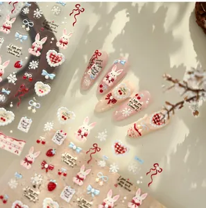 Detailed view of 3D embossed rabbit and strawberry nail art stickers for Christmas decor