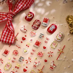 Macro detail of New Year nail stickers featuring red heart, horse, and plaid patterns