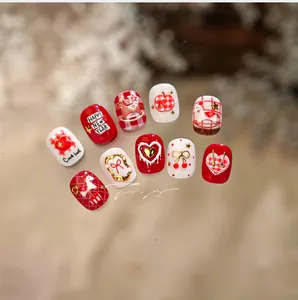 Detailed view of red and white New Year nail stickers with horse and heart patterns