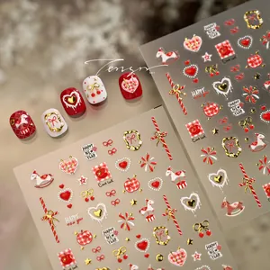 Detail of New Year nail art stickers featuring red hearts and gold horse patterns
