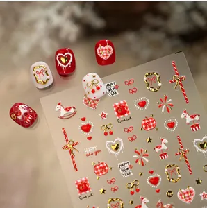 Detail of New Year nail stickers with 3D gold horse, hearts and festive red patterns