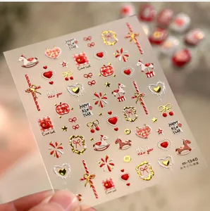 Macro shot of 3D New Year nail stickers featuring gold foil ponies and festive patterns