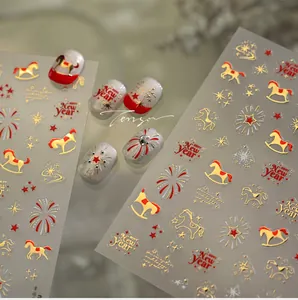 Macro view of New Year nail stickers featuring golden horses, fireworks and stars