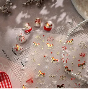 Detail of New Year nail stickers with gold stars, fireworks, and rocking horse patterns