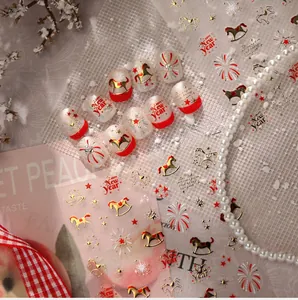 Macro detail of Chinese New Year nail stickers with gold horses, stars and festive patterns