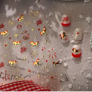 Detail of New Year nail stickers with gold horses, stars, and Happy New Year text