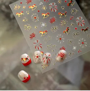 Detailed view of New Year nail decals with golden horse, fireworks and star patterns