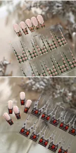 Detail of Christmas nail stickers with British plaid and winter bear patterns