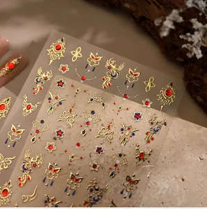 Macro view of Chinese vintage nail stickers featuring gold phoenix and floral embroidery