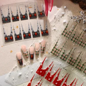 Christmas nail art stickers featuring red bows and holiday patterns on a snowy background