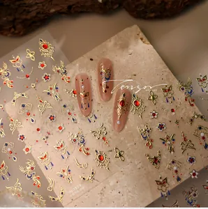 Macro detail of M-1324 nail stickers featuring golden phoenix and palace motifs