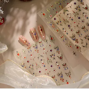 Detailed view of 3D embossed nail stickers with retro gold Phoenix and jewel patterns