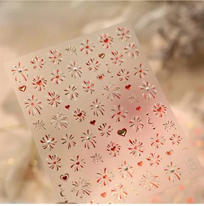 Macro detail of TL-452 New Year nail art stickers with red fireworks and heart designs