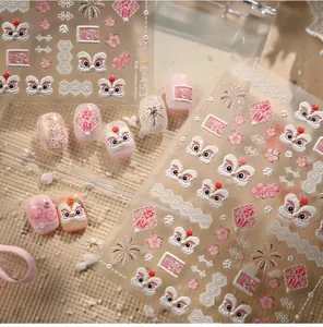 Detailed 3D embossed pink lion dance nail stickers with floral patterns and gold accents
