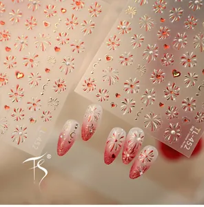 Close-up of TL-452 festive red and gold firework nail stickers with heart patterns
