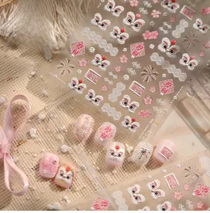 Macro shot of 5D embossed pink lion dance nail stickers with floral patterns